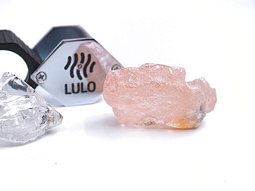 This photo supplied by Lucapa Diamond Company on Wednesday, July 27, 2022, shows the 170 carat pink diamond, right, recovered from Lulo, Angola. A big pink diamond of 170 carats has been discovered in Angola and is claimed to be the largest such gemstone found in 300 years. Called the &ldquo;Lulo Rose,&rdquo; the diamond was found at the Lulo alluvial diamond mine. The mine&rsquo;s owner, the Lucapa Diamond Company, on Wednesday announced the discovery of the large pink diamond on its website. (Lucapa Diamond Company via AP)