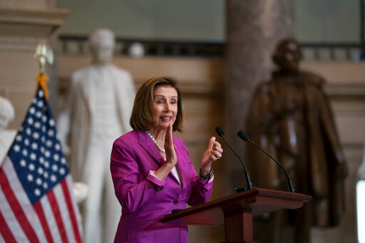 House Speaker Nancy Pelosi, D-Calif., hosts the dedication and unveiling ceremony of a statue in honor of Amelia Earhart, one of the world's most celebrated aviators and the first woman to fly solo across the Atlantic Ocean, in Statuary Hall, at the Capitol in Washington, Wednesday, July 27, 2022. The statue of Amelia Earhart will represent the State of Kansas in the National Statuary Hall Collection. (AP Photo/J. Scott Applewhite)