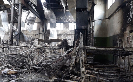 EDS NOTE: GRAPHIC CONTENT - In this photo taken from video a view of destroyed barrack at a prison in Olenivka, in an area controlled by Russian-backed separatist forces, eastern Ukraine, on July 29, 2022. Ukrainian officials say they are struggling to establish the truth surrounding the explosion in a prison that killed dozens of Ukrainian prisoners of war captured by the Russians following the fall of Mariupol. (AP Photo)