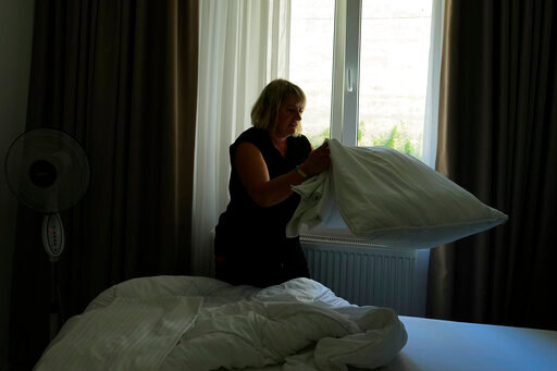 Ukrainian refugee Liudmyla Chudyjovych makes up a room in a hotel where she works, Wednesday, Aug. 3, 2022, in Prague, Czech Republic. Nearly six months after the Russian invasion of Ukraine, many refugees are still struggling to find jobs in their European Union host countries, despite the EU's streamlined process for Ukrainians to live and work in any of its 27 member nations. (AP Photo/Petr David Josek)