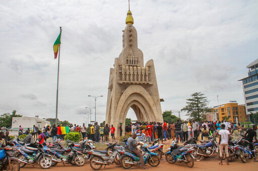 FILE - People gather at Place de l'Independence in Mali's capital Bamako, Aug. 19, 2020. Bamako, Mali's bustling riverside capital of more than 2.5 million people is on heightened alert as jihadi attacks have moved perilously close to the city. At least 15 extremist attacks hit Mali in June and July, the most daring when jihadi fighters attacked Kati, the country's largest military base, just 9 miles outside the capital. (AP Photo/Arouna Sissoko, File)