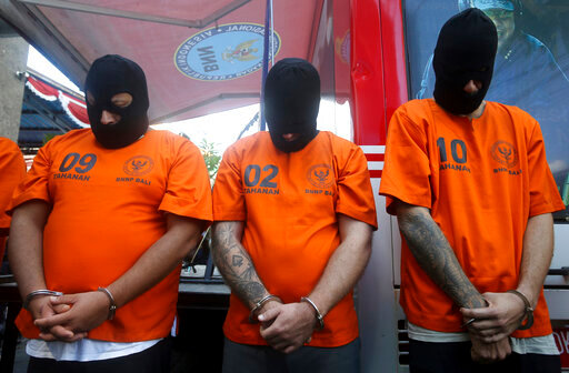 Foreign suspects detained on drugs charges are displayed during a news conference in Bali, Indonesia on Friday, Aug. 5, 2022. Authorities in Indonesia arrested three foreigners, for distributing cocaine on the Indonesian resort island of Bali at the end of July. From the three suspects that are identified as British, Brazilian and Mexican, the officers from the National Narcotics Agency seized 844.59 gram (1.86 pounds) of cocaine with other drugs, including MDMA and marijuana. (AP Photo/Firdia Lisnawati)
