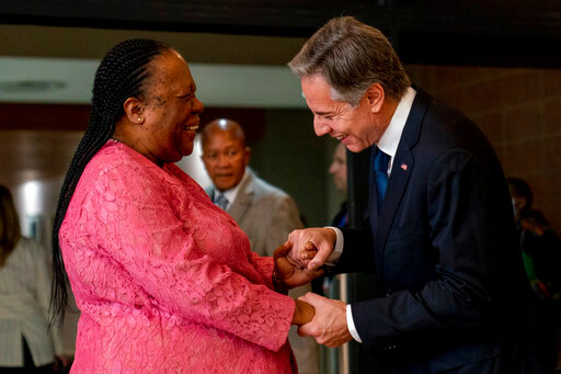 Secretary of State Antony Blinken is greeted by South Africa's Foreign Minister Naledi Pandor as he arrives for a meeting at the South African Department of International Relations and Cooperation in Pretoria, South Africa, Monday, Aug. 8, 2022. Blinken is on a ten day trip to Cambodia, Philippines, South Africa, Congo, and Rwanda. (AP Photo/Andrew Harnik, Pool)