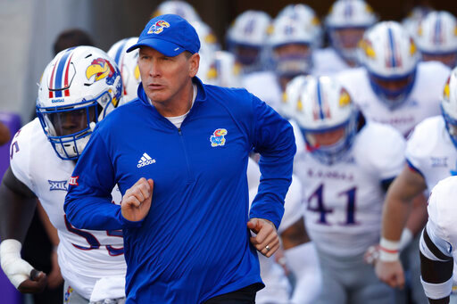 FILE - Kansas head coach Lance Leipold takes the field with his team before playing TCU in an NCAA college football game Saturday, Nov. 20, 2021, in Fort Worth, Texas. Leipold took over the football program at Kansas after a winless season and a somewhat scandalous departure of his predecessor, Les Miles. And while the long-time small-school coach won just twice in Year 1, he is full of optimism heading into fall camp this season. (AP Photo/Ron Jenkins, File)