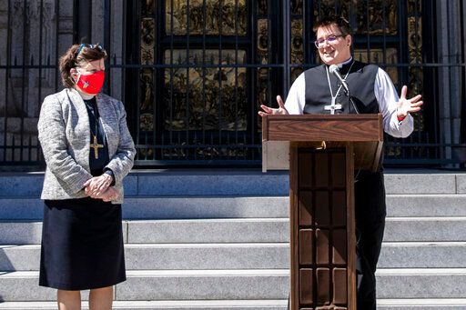FILE - Bishop Elizabeth Eaton, left, listens as Bishop Megan Rohrer speaks to the media before their installation ceremony at Grace Cathedral in San Francisco, Saturday, Sept. 11, 2021. Rohrer is the first openly transgender person elected as bishop in the Evangelical Lutheran Church of America. Eaton, presiding bishop of the Evangelical Lutheran Church in America, issued a public apology Tuesday, Aug. 9, 2022, to members of a majority Latino immigrant congregation for the pain and trauma caused after Rohrer unexpectedly fired their pastor. (AP Photo/John Hefti, File)