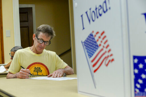 Sam Payne, of Dummerston, fills out a ballot at the Dummerston, Vt., Polling Station for the state's primary election, Tuesday, Aug. 9, 2022. (Kristopher Radder/The Brattleboro Reformer via AP)