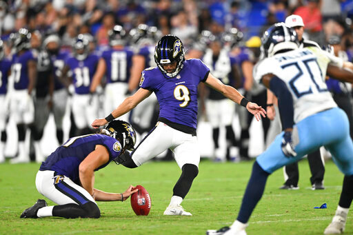Baltimore Ravens place kicker Justin Tucker (9), with Jordan Stout holding, kicks a field goal against the Tennessee Titans during the second half of a preseason NFL football game, Thursday, Aug. 11, 2022, in Baltimore. (AP Photo/Gail Burton)