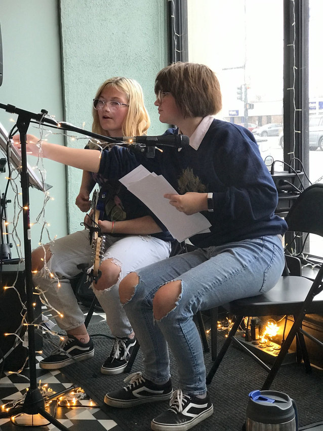 Zoe Goode, left, and Eden Darling, right, perform covers and original music at an open mic night at Root Coffeehouse in Pittsburg. The duo has been playing together for a year this month.