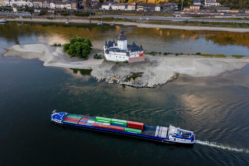 A container ships passes Pfalzgrafenstein castle in the middle of the river Rhine in Kaub, Germany, Friday, Aug. 12, 2022. The Rhine carries low water after a long drought period. (AP Photo/Michael Probst)
