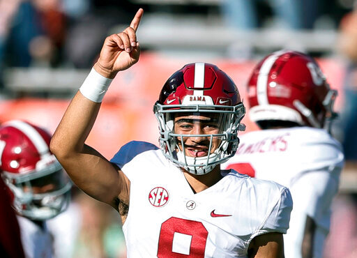 FILE - Alabama quarterback Bryce Young (9) during warm ups before the start of an NCAA college football game against Auburn Saturday, Nov. 27, 2021, in Auburn, Ala. Alabama is No. 1 in the preseason AP Top 25 for the second straight season. (AP Photo/Butch Dill, File)