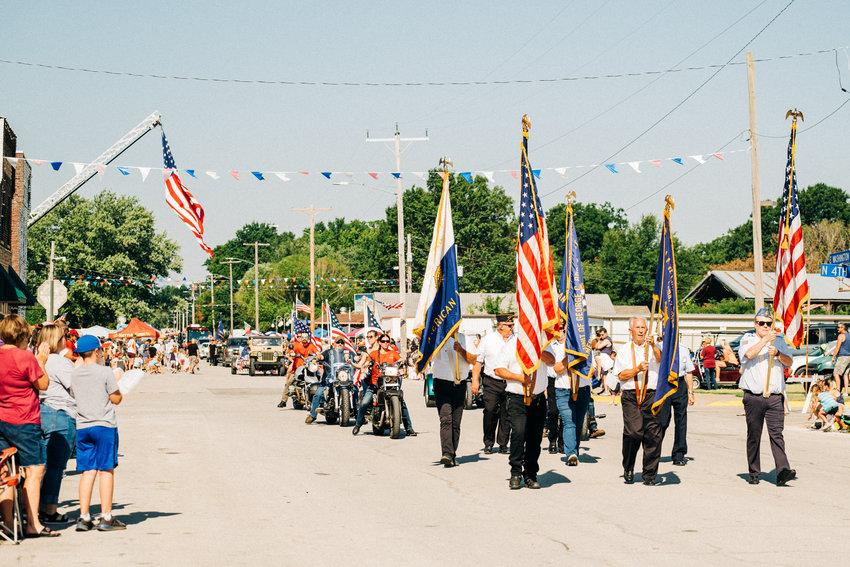 The American Legion leads Arma&rsquo;s homecoming parade as it makes its way through downtown Arma on Saturday, Aug. 13.