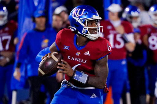 FILE - Kansas quarterback Jalon Daniels looks to pass the ball during an NCAA college football game against West Virginia Saturday, Nov. 27, 2021, in Lawrence, Kan. Kansas is set to kick off its season on Sept. 2, 2022, against Tennessee Tech. (AP Photo/Ed Zurga, File)