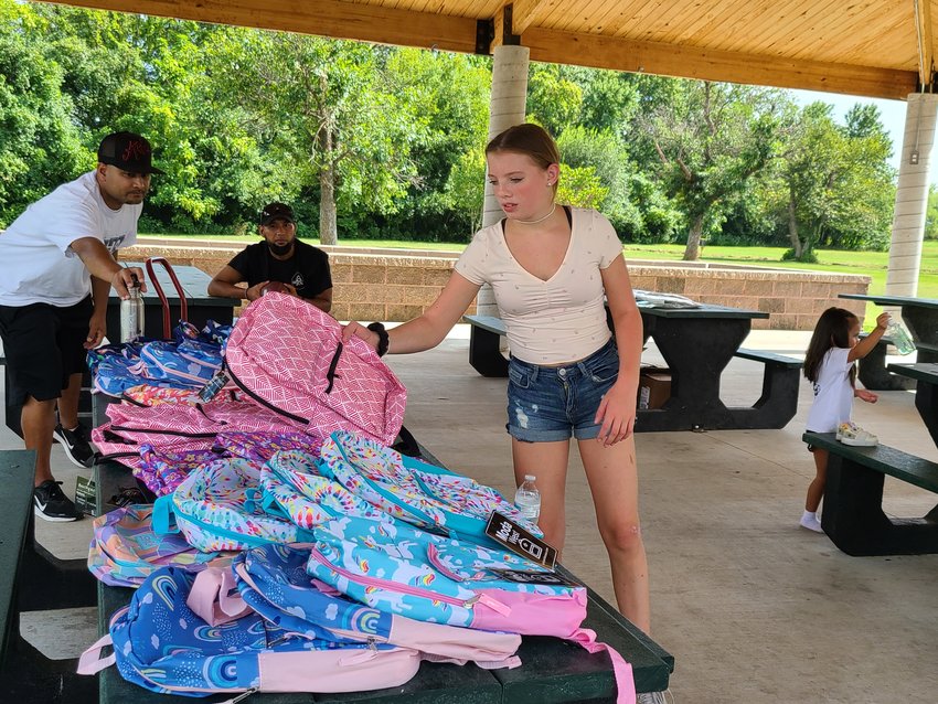 Molly Alartosky selects a backpack during an event Friday where members of the local Marshallese community provided free backpacks to children at Schlanger Park.