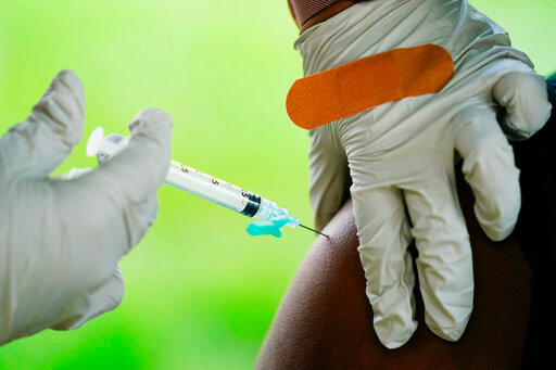 FILE - A health worker administers a dose of a Pfizer COVID-19 vaccine during a vaccination clinic in Reading, Pa., Sept. 14, 2021. Pfizer asked U.S. regulators Monday, Aug. 22, 2022, to authorize its combination COVID-19 vaccine that adds protection against the newest omicron mutants &mdash; a key step toward opening a fall booster campaign. (AP Photo/Matt Rourke, File)