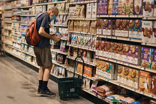 FILE - A man shops at a supermarket on Wednesday, July 27, 2022, in New York.  U.S. demand for grocery delivery is cooling as food prices rise. Some shoppers are shifting to less expensive grocery pickup, while others are returning to the store.  (AP Photo/Andres Kudacki)