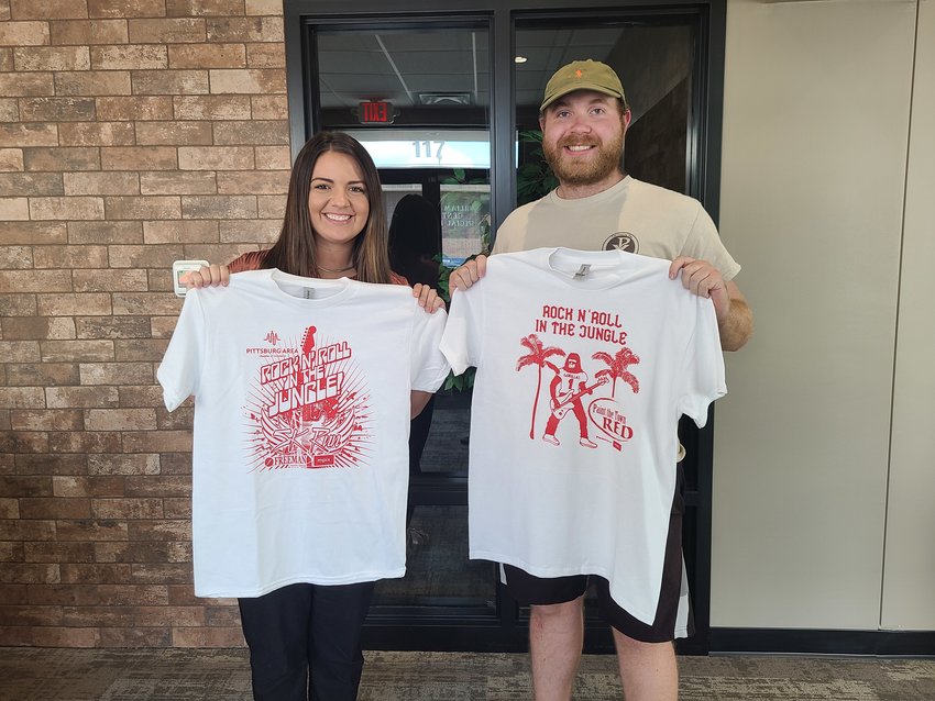 Paint the Town Red t-shirts featuring this year&rsquo;s theme, &ldquo;Rock N&rsquo; Roll in the Jungle,&rdquo; are now available at the Pittsburg Area Chamber of Commerce, 117 W. 4th St., following a contest to come up with a design for the shirts. Pictured are Chamber Membership and Special Events Director Tori Colvin, left, holding the Paint the Town Red 5K shirt designed by Sign Brothers while Andrew Day holds the Paint the Town Red shirt he designed.