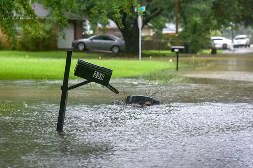 A mailbox stands in floodwaters from heavy rains that have plagued the region in recent days on Foxboro Drive in northeast Jackson, Miss., Wednesday, Aug. 24, 2022. Torrential rains and flash flooding prompted rescue operations, closures and evacuations in the central part of the state. (Hannah Mattix/The Clarion-Ledger via AP)