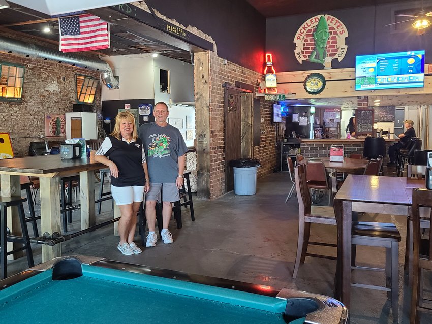 Stacey Temaat Kennedy, left, and her husband John Kennedy stand in from of the remodeled space of Pickled Pete&rsquo;s Bar and Grill, which they now own.