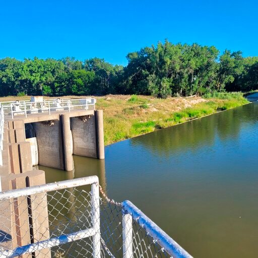 Sluice gates at the Cambridge Canal in south-central Nebraska, are pictured Monday, Aug. 22, 2022. It's a mystery why someone released 16 million gallons of water out of the canal one night earlier this month. (Bradley Edgerton via AP)