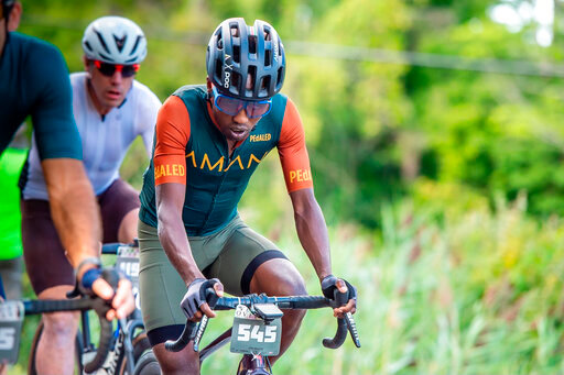 In this photo provided by Joseph Viger, Kenyan cyclist Sule Kangangi cycles at a gravel race in Vermont, Saturday, Aug. 27, 2022. Kangangi died in a crash later in the day, while competing in the race. (Joseph Viger via AP)