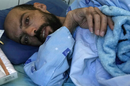 FILE - Khalil Awawdeh, a Palestinian who has been on a hunger strike for several months protesting being jailed without charge or trial under what Israel refers to as administrative detention, lies in bed at Asaf Harofeh Hospital in Be'er Ya'akov, Israel, Wednesday, Aug. 24, 2022.  Awawdeh, a Palestinian detainee held without charge or trial by Israel will suspend his nearly six-month hunger strike after receiving a &ldquo;written agreement&rdquo; that he will be released in October, Palestinian officials said Wednesday, Aug. 31.  (AP Photo/ Mahmoud Illean, File)