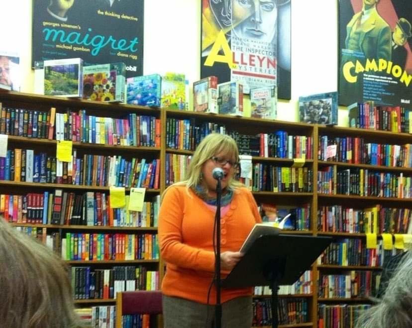 Poet Laura Lee Washburn reads from one of her books of poetry at Raven Bookstore in Lawrence.