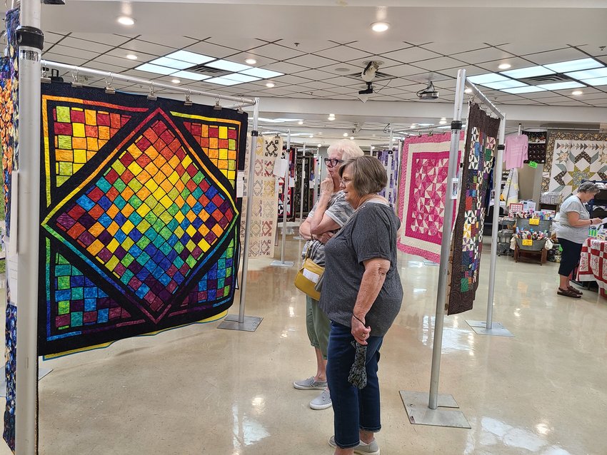 Barbara Phipps, left, and Linda Morgan comment on the time it would have taken to make one of the quilts at the Little Balkans Quilt Show on Friday, Sept. 2, 2022.