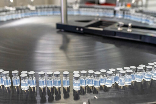 This August 2022 photo provided by Pfizer shows vials of the company's updated COVID-19 vaccine during production in Kalamazoo, Mich.  U.S. regulators have authorized updated COVID-19 boosters, the first to directly target today's most common omicron strain. The move on Wednesday, Aug. 13, 2022,  by the Food and Drug Administration tweaks the recipe of shots made by Pfizer and rival Moderna  that already have saved millions of lives.  (Pfizer via AP)