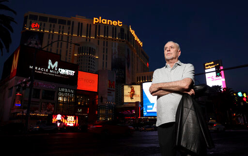 Jeff German, host of &quot;Mobbed Up,&quot; poses with Planet Hollywood, formerly the Aladdin, in the background on the Strip in Las Vegas, Wednesday, June 2, 2021. Authorities say German, a Las Vegas investigative reporter has been stabbed to death outside his home and police are searching for a suspect. The Las Vegas Review-Journal says officers found journalist German dead with stab wounds around 10:30 a.m. Saturday, Sept. 3, 2022, after authorities received a 911 call. (K.M. Cannon/Las Vegas Review-Journal via AP)