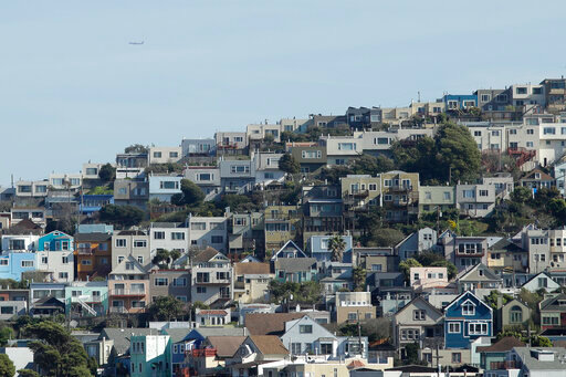 FILE - A plane flies over homes and residential buildings in San Francisco, Wednesday, March 4, 2020. California lawmakers have reached a deal on a pair of housing production bills. The bills would open up much of the state's commercial land for residential development. California has a housing shortage. (AP Photo/Jeff Chiu, File )