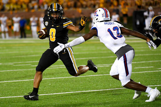 Missouri running back BJ Harris (0) scores on a touchdown run past Louisiana Tech defensive back Myles Brooks (13) during the second half of an NCAA college football game Thursday, Sept. 1, 2022, in Columbia, Mo. Missouri won 52-24. (AP Photo/L.G. Patterson)