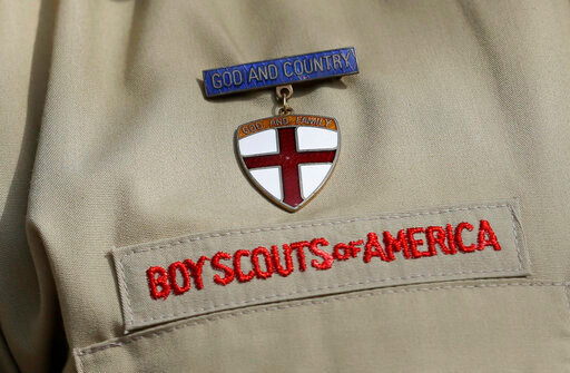 FILE - A close up of a Boy Scout uniform is photographed on Feb. 4, 2013, in Irving, Texas. A Delaware bankruptcy judge has approved a $2.46 billion reorganization plan Thursday, Sept. 8, 2022, proposed by the Boy Scouts of America that would allow it to continue operating while compensating tens of thousands of men who say were sexually abused as children while involved in Scouting. (AP Photo/Tony Gutierrez, File)