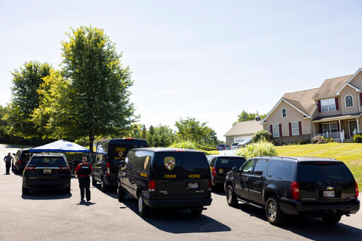 Law enforcement gather at the scene Friday, Sept. 9, 2022, in Elk Mills, Md., about 60 miles (97 km) northeast of Baltimore. Five people were found dead inside a home in northeastern Maryland on Friday after deputies were called to investigate a report of a shooting, authorities said. (AP Photo/Ryan Collerd)