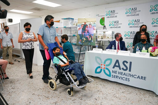 In this photo provided by Clifford Law Offices, Karina Aguilar, her husband, Temo Aguilar, and their son Felipe Aguilar attend a news conference on Aug. 3, 2021, at the office of ASI/NE Healthcare Services in Chicago. After Itza Pantoja's severely disabled son died at the age of 16, she made it her mission to ensure that the wheelchairs, beds and other equipment and supplies that had helped him got to others who needed them. Many of the items, including a car seat, standing chair and bed, went to Felipe Aguilar, a 12-year-old Chicago boy with cerebral palsy. (Clifford Law Offices, Chicago via AP)