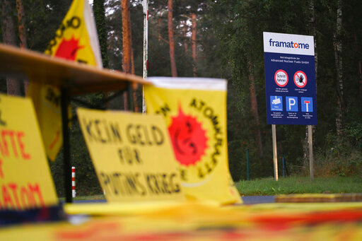 Protest posters are placed in front of the fuel element fabrication plant of the 'framatome' company in Lingen, Gerany, Monday, Sept. 12, 2022. The German government said Monday that it can't stop a shipment of Russian uranium destined for French nuclear plants from being processed at a site in Germany because atomic fuel isn't covered by European Union sanctions on Russia. (Lars Klemmer/dpa via AP)