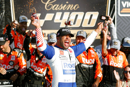 Bubba Wallace celebrates in Victory Lane after winning a NASCAR Cup Series auto race at Kansas Speedway in Kansas City, Kan., Sunday, Sept. 11, 2022. (AP Photo/Colin E. Braley)