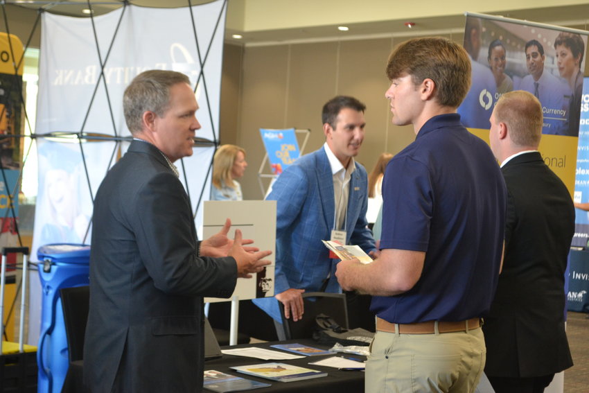 National Bank Examiner for the U.S. Department of Treasury Office of the Comptroller of the Currency Matt Gilmore discusses details of jobs with junior Brock Bruggeman at Pittsburg State University&rsquo;s Meet the Firms on Monday afternoon. Meet the Firms is a specialized career fair for business-related majors such as accounting, computer information systems, auditing, and finance. Businesses both local and with operations nationwide showed up to talk about job opportunities with future graduates.