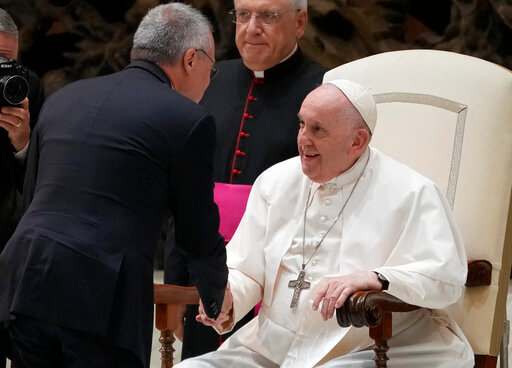 Pope Francis greets Italian Industrialists Association President Carlo Bonomi during an audience in the Paul VI Hall at The Vatican, Monday, Sept. 12, 2022 (AP Photo/Andrew Medichini)