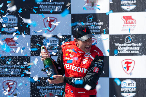 Team Penske driver Will Power, of Australia, celebrates after winning third place in the IndyCar season finale auto race at Laguna Seca Raceway on Sunday, Sept. 11, 2022, Monterey, Calif. Power also won the 2022 championship.(AP Photo/Nic Coury)
