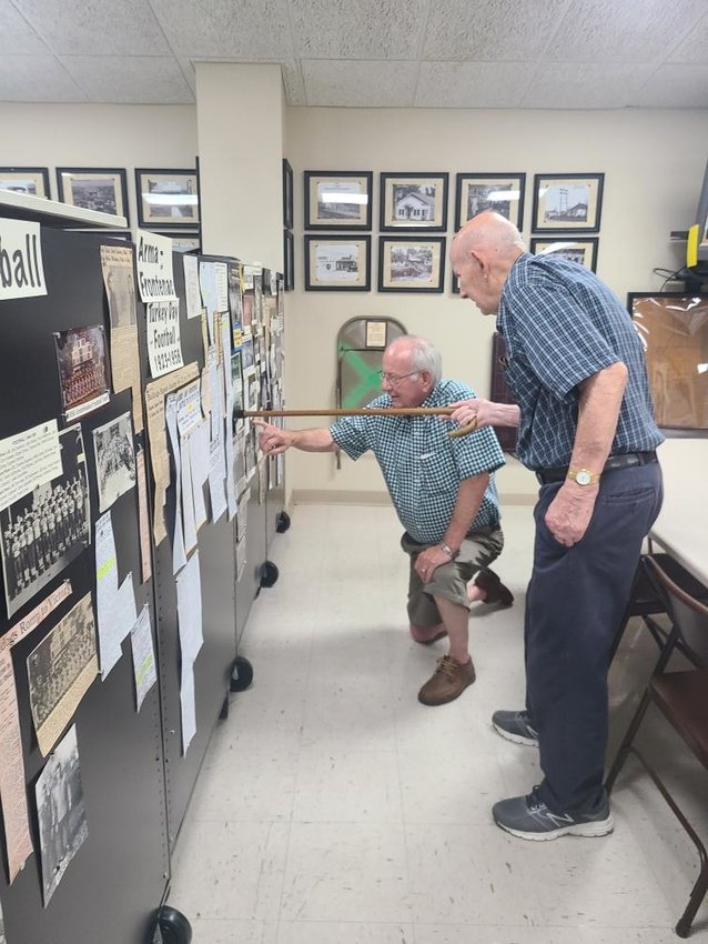Jim Barone, left, and Pat Barone find pictures of people they knew in high school at the &ldquo;A Winning Team&rdquo; exhibit at Miners Hall Museum.