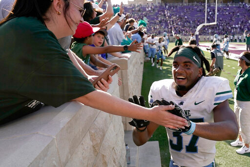 Tulane safety Macon Clark celebrates with fans after an NCAA college football game against Kansas State Saturday, Sept. 17, 2022, in Manhattan, Kan. Tulane won 17-10. (AP Photo/Charlie Riedel)
