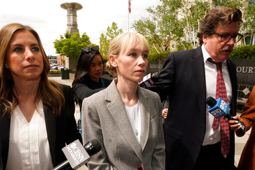 FILE - Sherri Papini of Redding walks to the federal courthouse accompanied by her attorney, William Portanova, right, in Sacramento, Calif., Wednesday, April 13, 2022. Papini is scheduled to appear in federal court, Monday, Sept. 19, 2022, where prosecutors are asking that she be sentenced to eight months in prison for faking her own kidnapping in 2016. (AP Photo/Rich Pedroncelli, File)