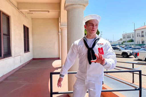 US Navy sailor Ryan Sawyer Mays walks past reporters at Naval Base San Diego before entering a Navy courtroom Wednesday, Aug. 17, 2022, in San Diego. Mays is accused of setting the USS Bonhomme Richard on fire, and his court martial is scheduled to begin Monday, Sept. 19, 2022. The July 2020 blaze damaged the billion-dollar warship so badly it had to be scuttled and marked one of the worst noncombat US warship disasters in recent memory. (AP Photo/Julie Watson)
