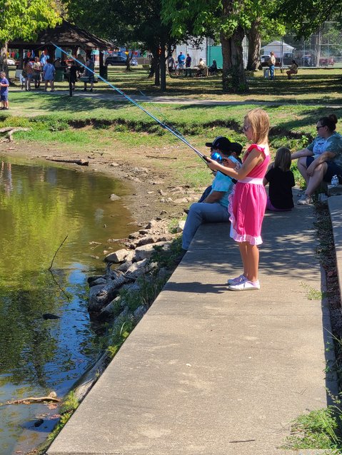 New Cub Scouts member Lorelei Hively waits patiently after casting her line at the Hooked on Scouting event in Lakeside Park on Saturday.