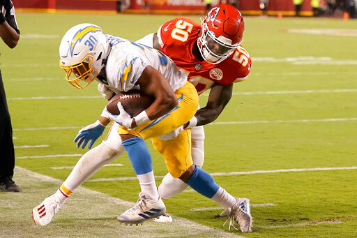 Kansas City Chiefs linebacker Willie Gay (50) tackles Los Angeles Chargers running back Austin Ekeler (30) during the second half of an NFL football game Thursday, Sept. 15, 2022, in Kansas City, Mo. The Chiefs won 27-24. (AP Photo/Charlie Riedel)