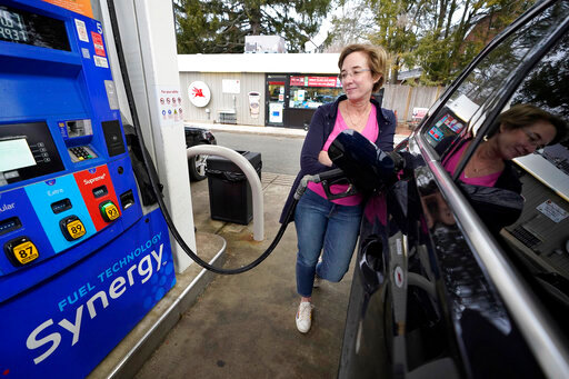 FILE - Jennifer Quinn fills her SUV at a gas station Monday, March 7, 2022, in Needham, Mass. The average price of regular gasoline nationwide is up slightly Wednesday, Sept. 21, from a day earlier, the first time prices have climbed in 99 days.   (AP Photo/Steven Senne)