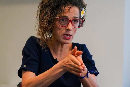 Iranian dissident Masih Alinejad gestures as she speaks during an interview with The Associated Press, Friday, Sept. 23, 2022, in New York. (AP Photo/Mary Altaffer)