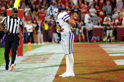 Kansas State quarterback Adrian Martinez (9) bows after scoring a touchdown against Oklahoma in the second half of an NCAA college football game, Saturday, Sept. 24, 2022, in Norman, Okla. (AP Photo/Nate Billings)