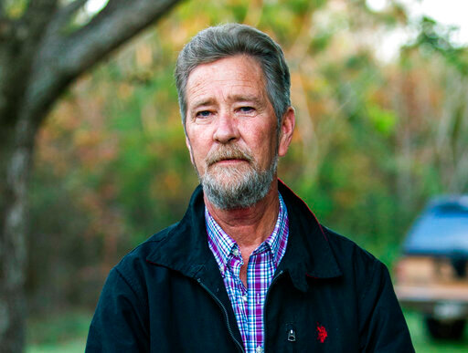 FILE - Leslie McCrae Dowless Jr. poses for a portrait outside of his home on Dec. 5, 2018, in Bladenboro, N.C. Four people pled guilty Monday, Sept. 26, 2022, to misdemeanors for their roles in absentee ballot fraud in rural North Carolina during the 2016 and 2018 elections. The defendants were associated with Dowless, a political operative in Bladen County whom authorities called the ringleader of the ballot scheme. Dowless died earlier in 2022 before his case went to trial. (Travis Long/The News &amp; Observer via AP, File)