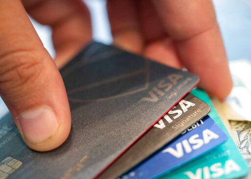 FILE - This Aug. 11, 2019 file photo shows Visa credit cards in New Orleans. With interest rates rising, the cost of borrowing is going up. This is especially the case for credit cards, as they have high annual percentage rates that vary as interest rates change.  (AP Photo/Jenny Kane, File)
